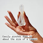 Hand holding a Flex Reusable Disc showing how to pinch for insertion.