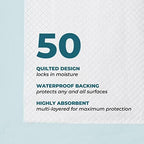 Green Lifestyle disposable pads being utilized as pet training pee sheets for a puppy on a tiled floor.
