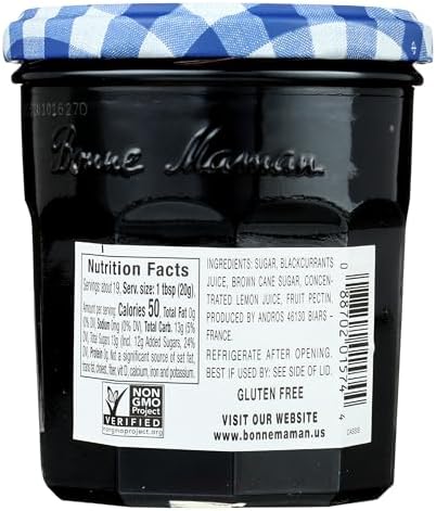 Authentic Bonne Maman blackcurrant conserve jar on a kitchen table showcasing ingredients and smooth purple texture
