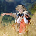 Four pack of beige mosquito head netting for camping and hiking