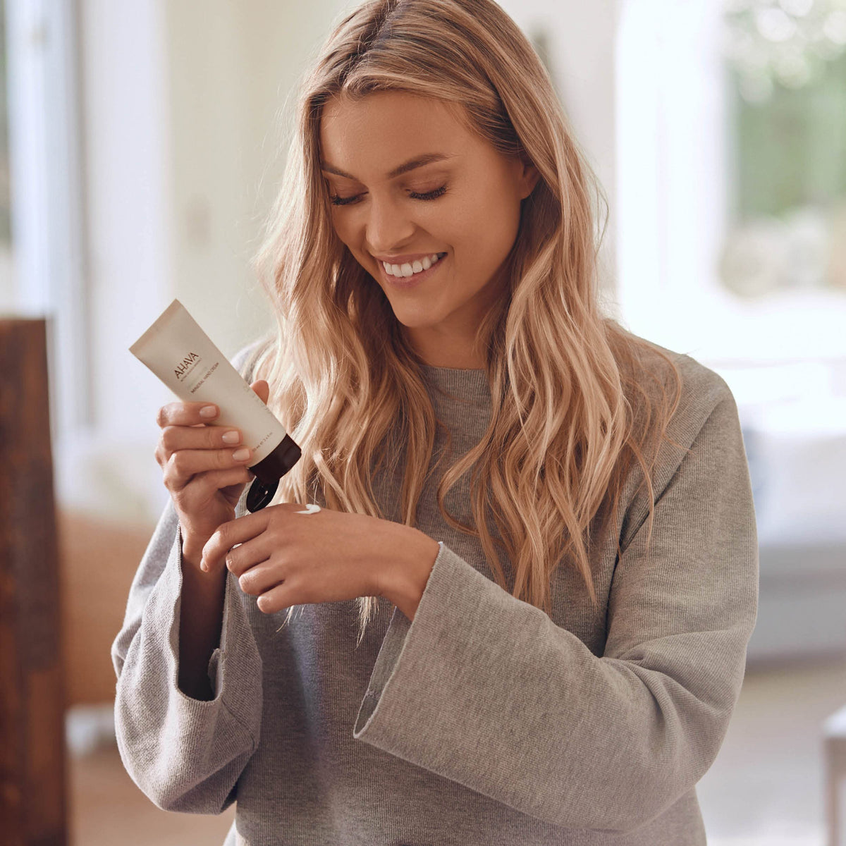 AHAVA hand cream application on skin demonstrating soothing Allantoin benefits