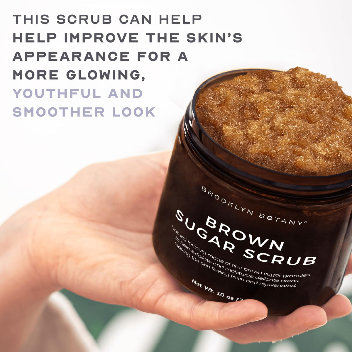 Brooklyn Botany skincare scrub being applied to hands demonstrating its gentle moisturizing texture.