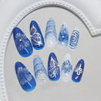 Close up of 3D pearl bow accent on blue gradient press on nails