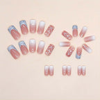 Close up of pink ombre square press on nails with heart detail