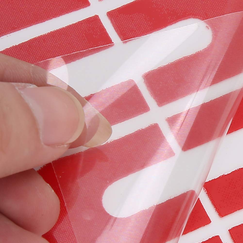 Side angle of a salon professional applying a red adhesive nail guard onto a client's finger before painting.