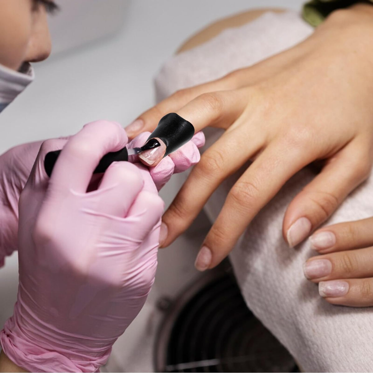 Close up of Outus skin barrier tape preventing edge overflow on fingernails
