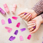 Hand wearing pink and purple silicone nail polish finger protectors