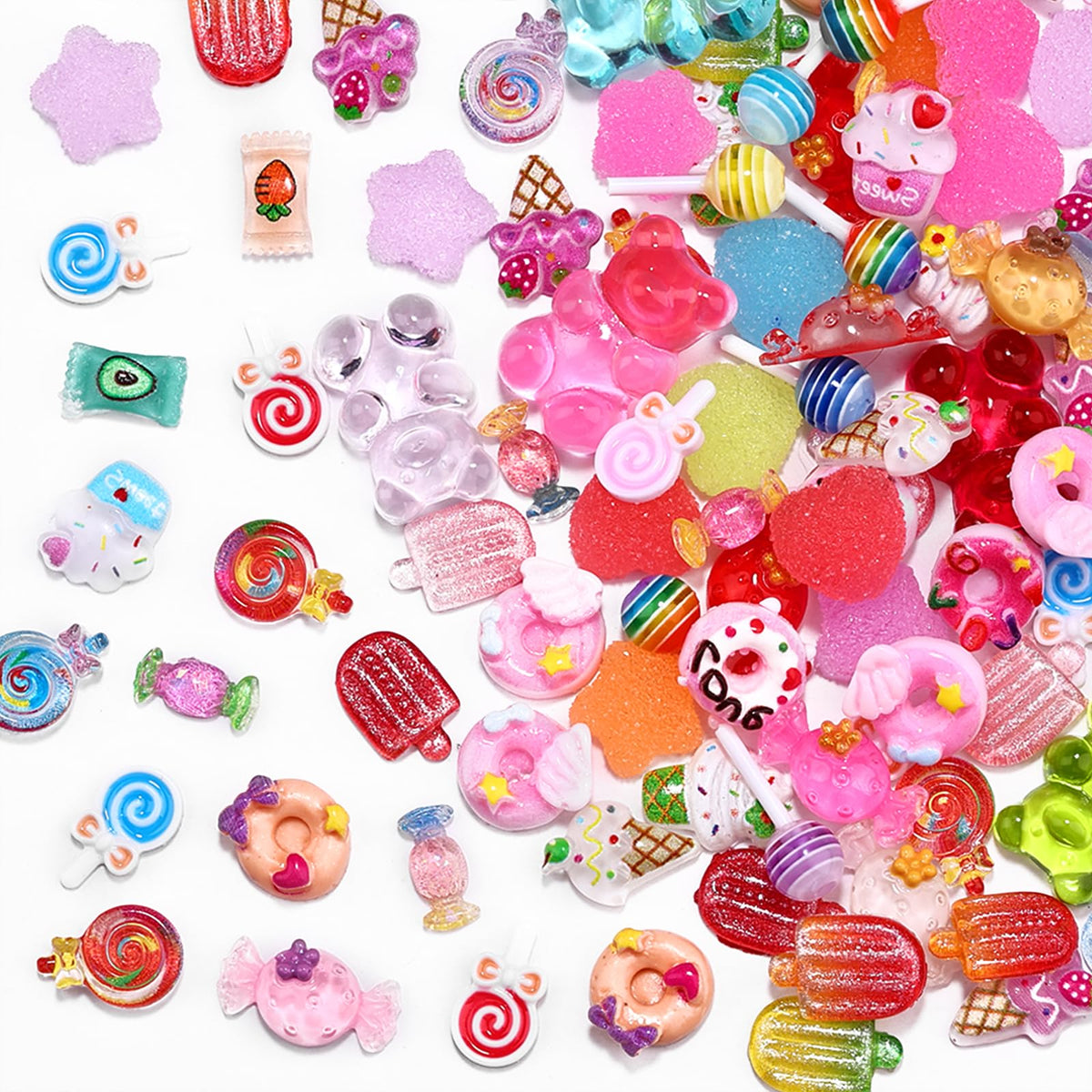 Various 3D sweet-themed nail charms displayed on a surface