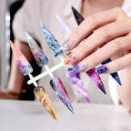 Kalolary nail art foil transfer stickers applied over dark gel polish under a professional salon UV LED lamp setup.