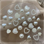 Top view of pearl nail jewelry set in organized storage