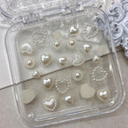 Hand holding heart shaped flatback pearls for size reference