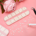Beige pearl 3D nail charms in organized storage grid