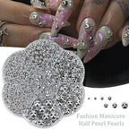 Craft supplies showing silver pearls and application tools
