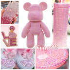 Pink resin rhinestones arranged for tumbler DIY project
