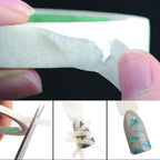 White stencil striping line tapes being applied to fingertips for geometric line art