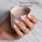 Model showcasing a completed light pink glossy manicure using Blushing Bunny semi cured strips.