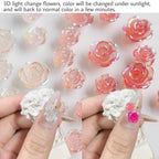 Finished DIY acrylic manicure adorned with sunlight reactive flower charms and delicate pearls.