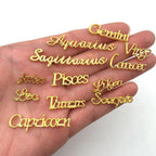 Detailed shot of individual pieces including Scorpio Leo and Taurus word charms.