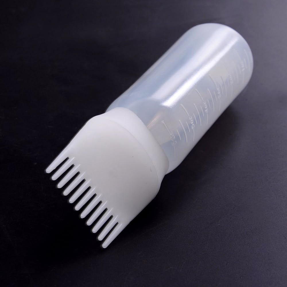 Pink squeezable plastic root applicator comb bottle highlighting flexible material construction