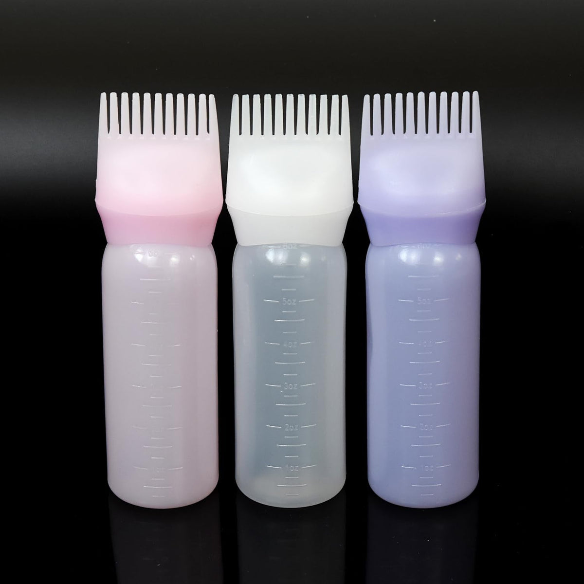 Close up of the customizable comb applicator nozzle showing fluid delivery holes for oiling
