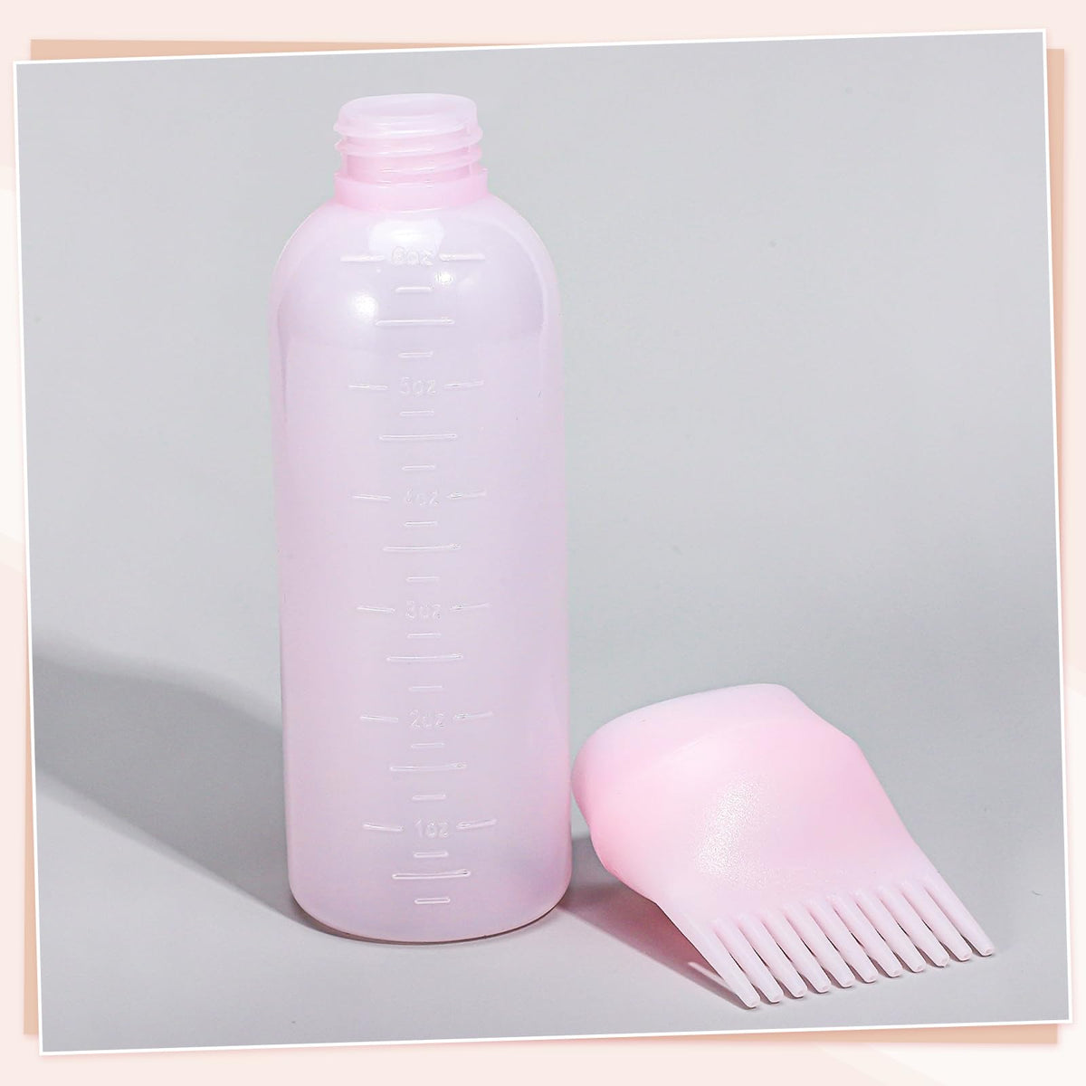 Flexible plastic body of the Pimoys scalp applicator bottle being gently squeezed to demonstrate liquid flow control.