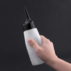 Yebeauty clear hair color mixer bottle being filled with hair treatment liquid