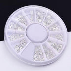 Durable stainless steel alloy ocean series nail studs displayed on a flat surface for DIY manicure sizing.