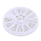 Premium silver metallic 3D nail art embellishments featuring realistic ocean shells and starfish shapes.