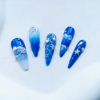 Two boxes of ONEUPIN beach theme nail rhinestones and silver alloy rivets for salon quality styling.