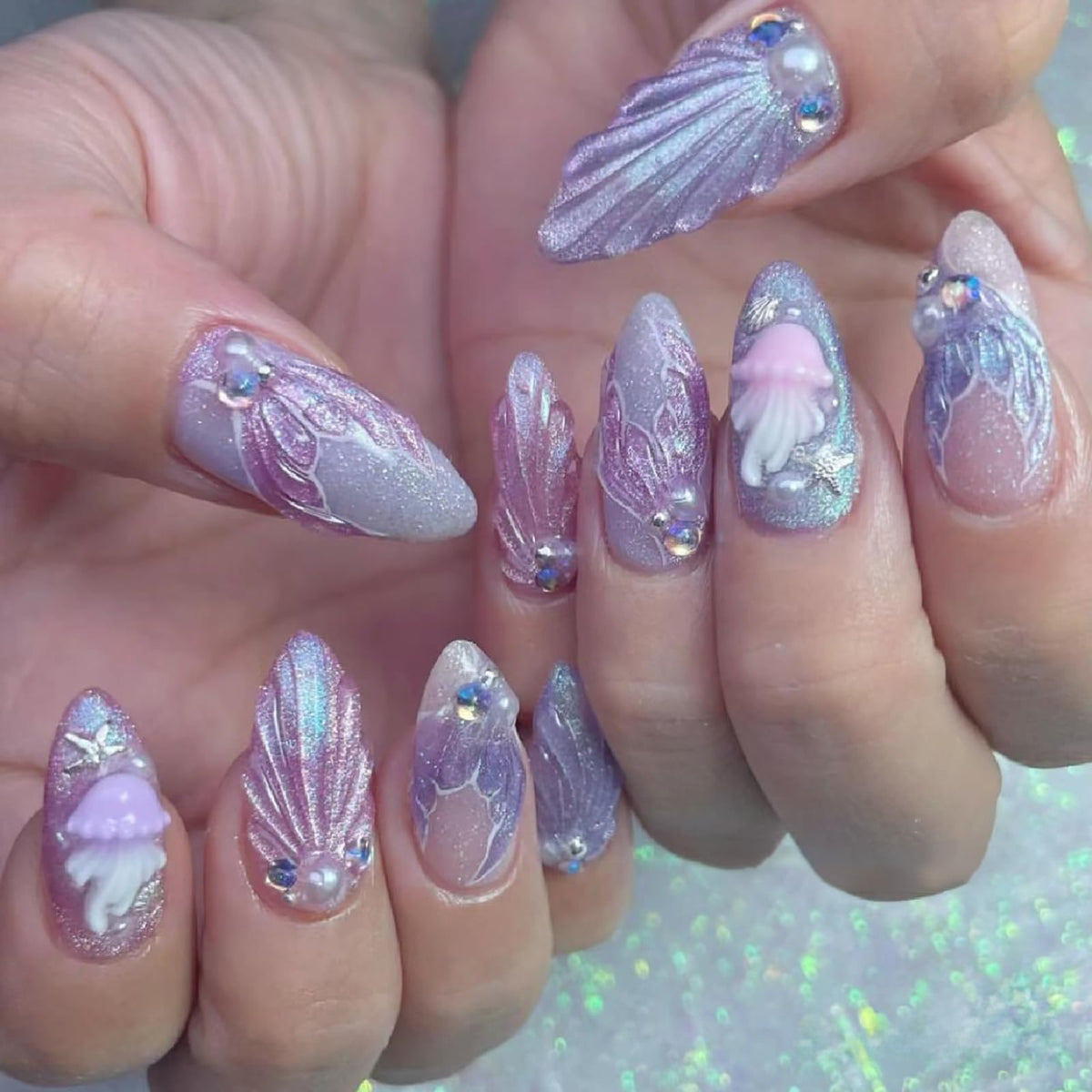 Detailed look at the twelve unique coastal patterns within the ONEUPIN silver nail art kit.