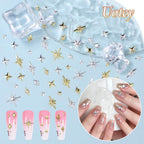 Close up view of intricate gold star charms applied neatly onto an elegant gel manicure design