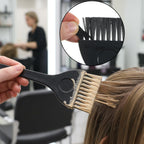 Hairstylist using balayage board for precise hair color application