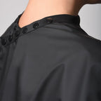 Framar salon cape showing adjustable snap closure details