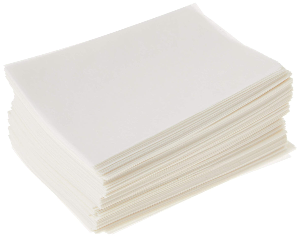 Stack of white paper end wraps for hair salon treatments