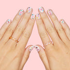 Girl applying Xo, Fetti nail stickers during a DIY party activity