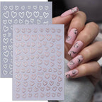Detailed view of gold and silver heart nail decals