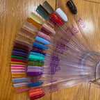 Three sets of 50 nail practice sticks with metal rings