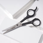 Tweezerman 5.5 inch stainless steel hair shears showcasing the micro-serrated blades.