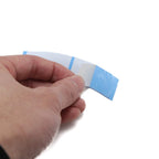 NEITSI Walker Ultra Hold Mini Tabs backing paper showing the easy peel liner side of the strong toupee tape