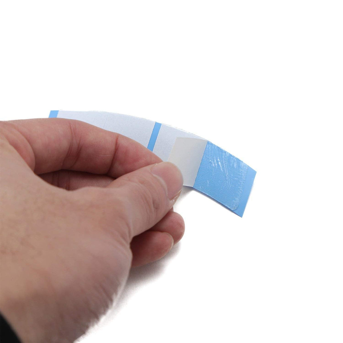 NEITSI Walker Ultra Hold Mini Tabs backing paper showing the easy peel liner side of the strong toupee tape