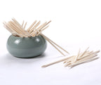Pointed tip of orange wood stick for nail art precision