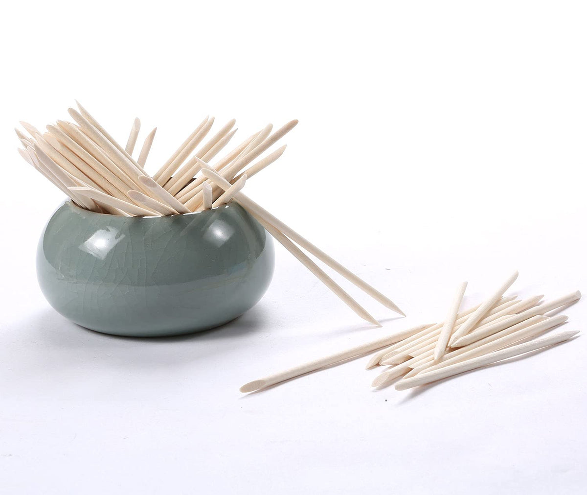 Pointed tip of orange wood stick for nail art precision