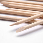 Professional nail care with orange wood sticks