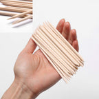 Hand holding Borogo wooden manicure tool for cuticle care