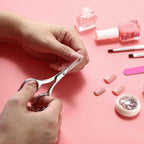 LIVINGO pedicure scissors being held to demonstrate the secure fatigue free handling design.