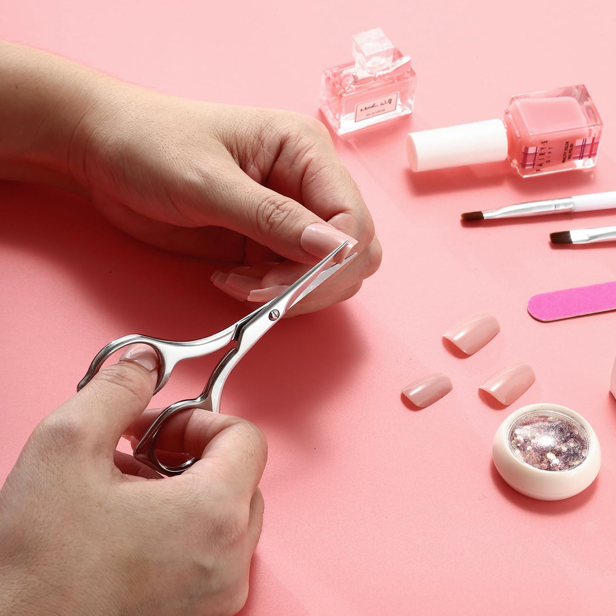 LIVINGO pedicure scissors being held to demonstrate the secure fatigue free handling design.