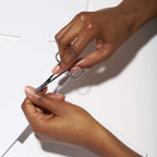 Ergonomic finger loops of Tweezerman cuticle scissors highlighting the comfortable grip design for stable grooming control