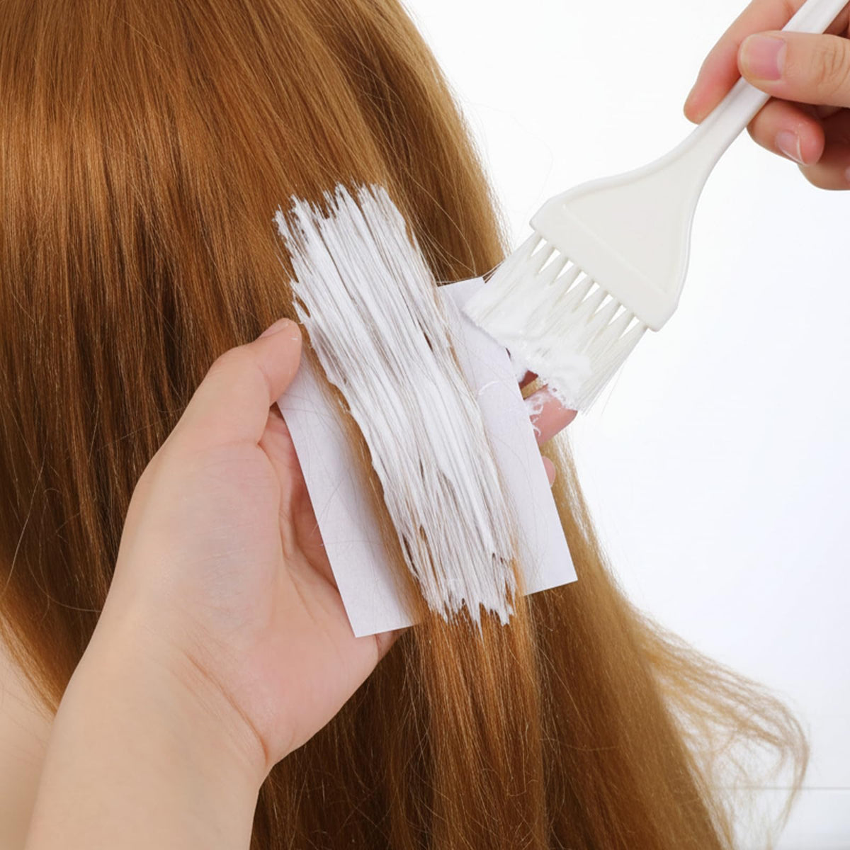 TIESOME end papers for hot and cold perms being applied to hair rollers.