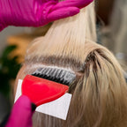 Professional stylist using TIESOME disposable end papers on hair rollers for a hot perm treatment.