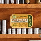 Duke Cannon solid cologne open tin showing concentrated balm